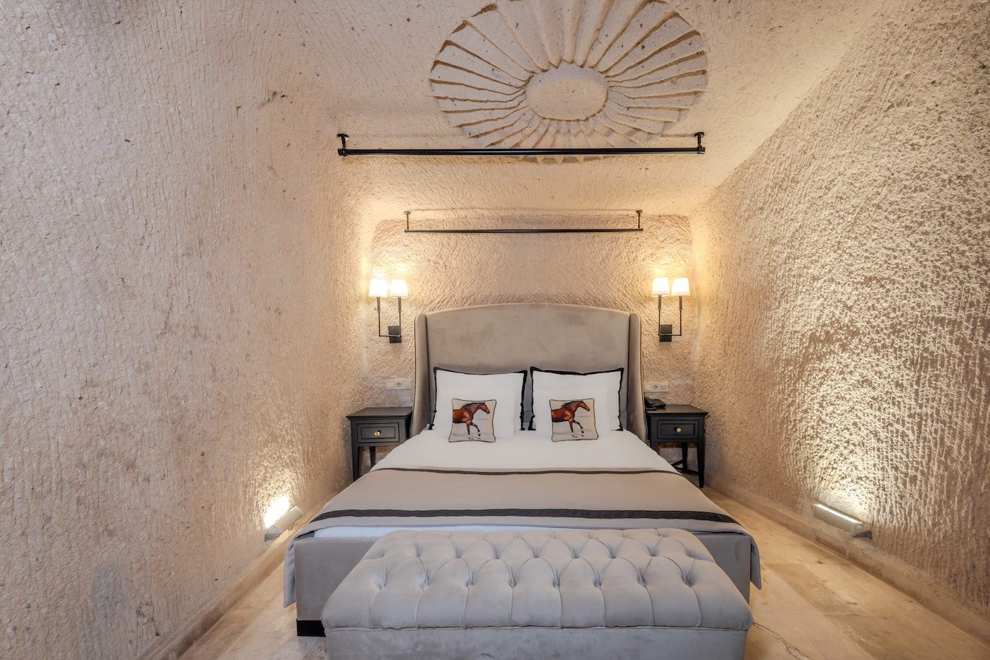 Bedroom with textured walls, bed, and decorative elements.